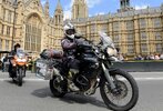 A motorcyclist in front of the Parliament building. A motorcyclist in front of the Parliament building.