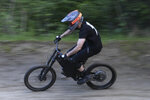 Helmeted rider descends off-road trail at speed on Stealth B-52 Bomber eBike Helmeted rider descends off-road trail at speed on Stealth B-52 Bomber eBike