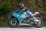 Man riding Lightning LS-218 electric motorcycle on the road at speed Man riding Lightning LS-218 electric motorcycle on the road at speed