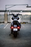 BMW's CE-04 electric scooter on a carpark rooftop at sunset BMW's CE-04 electric scooter on a carpark rooftop at sunset