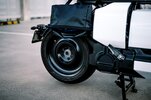 The rear wheel of BMW's CE-04 electric scooter on a carpark rooftop at sunset The rear wheel of BMW's CE-04 electric scooter on a carpark rooftop at sunset
