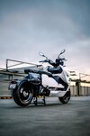 BMW's CE-04 electric scooter on a carpark rooftop at sunset BMW's CE-04 electric scooter on a carpark rooftop at sunset