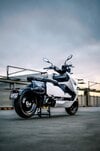 BMW's CE-04 electric scooter on a carpark rooftop at sunset BMW's CE-04 electric scooter on a carpark rooftop at sunset