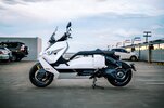 BMW's CE-04 electric scooter on a carpark rooftop at sunset BMW's CE-04 electric scooter on a carpark rooftop at sunset