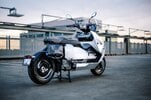 BMW's CE-04 electric scooter on a carpark rooftop at sunset BMW's CE-04 electric scooter on a carpark rooftop at sunset
